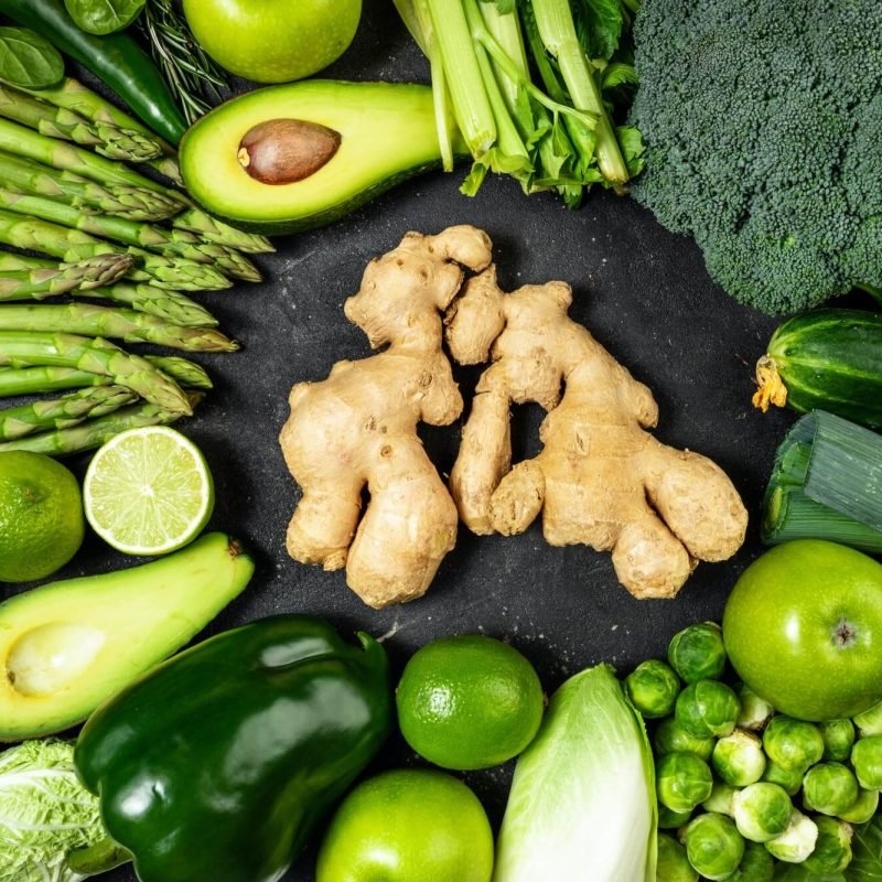 healthy-food-clean-eating-green-vegetables-fruits-and-ginger-on-dark-stone-background-1.jpg